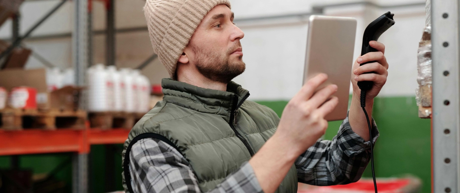 Ein Mitarbeiter arbeitet im Lager und nutzt moderne Technologien zur Optimierung der Logistikprozesse.